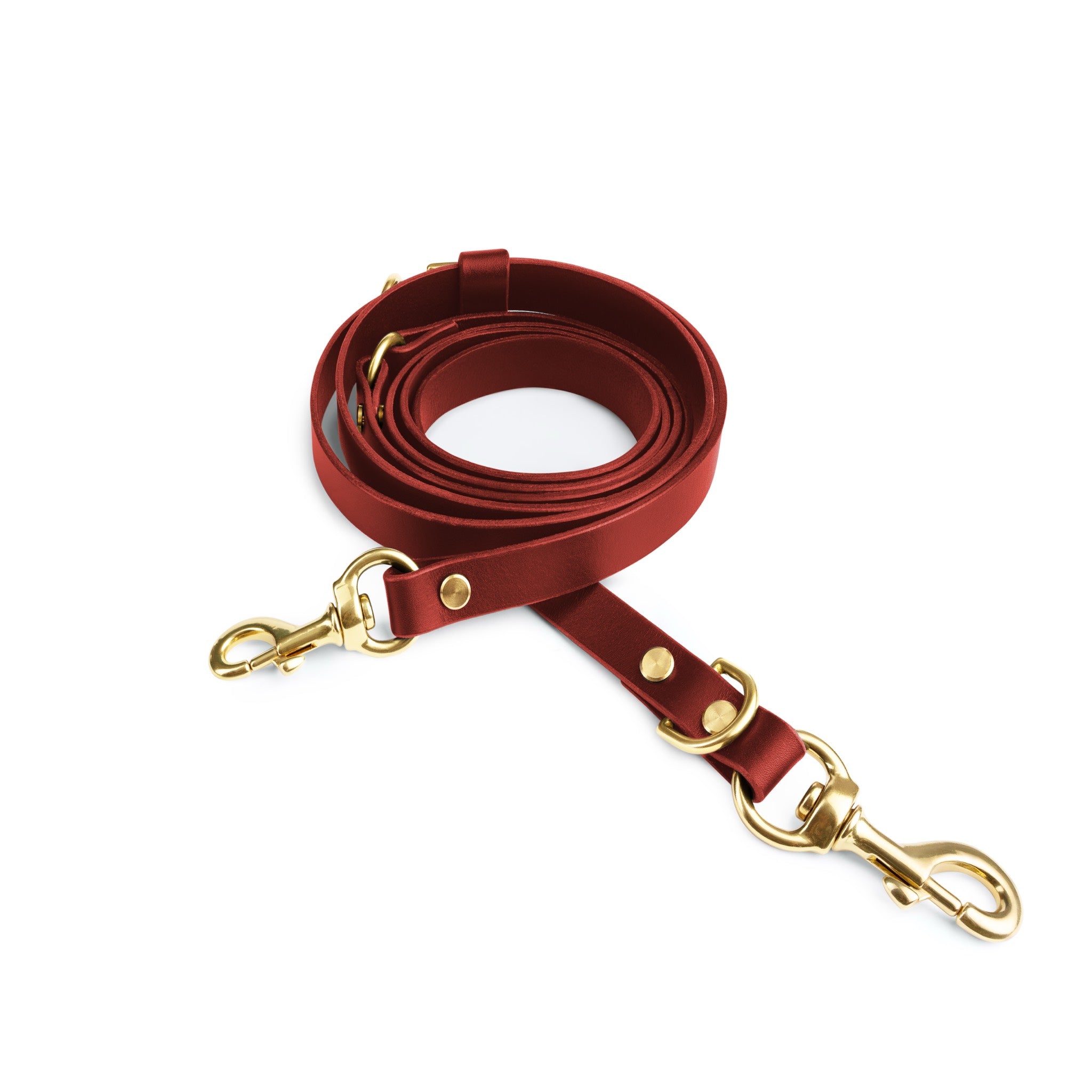 Aura hands-free leather dog leash in burgundy red with adjustable strap and metal clip, designed for comfortable walking.