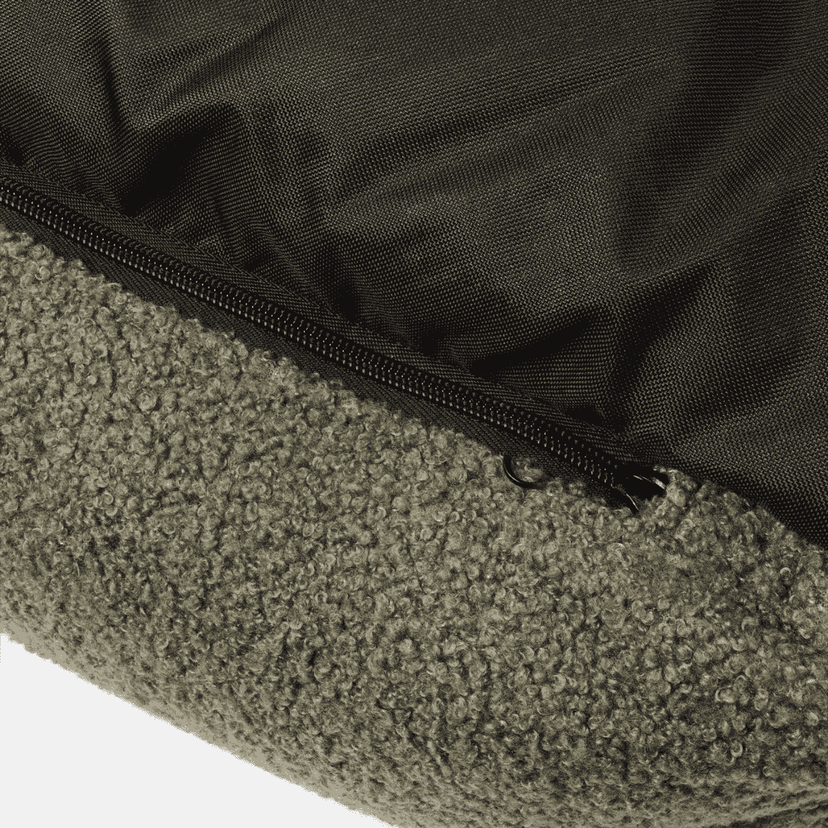 Close-up of a textured green bag with a zipper on a white background