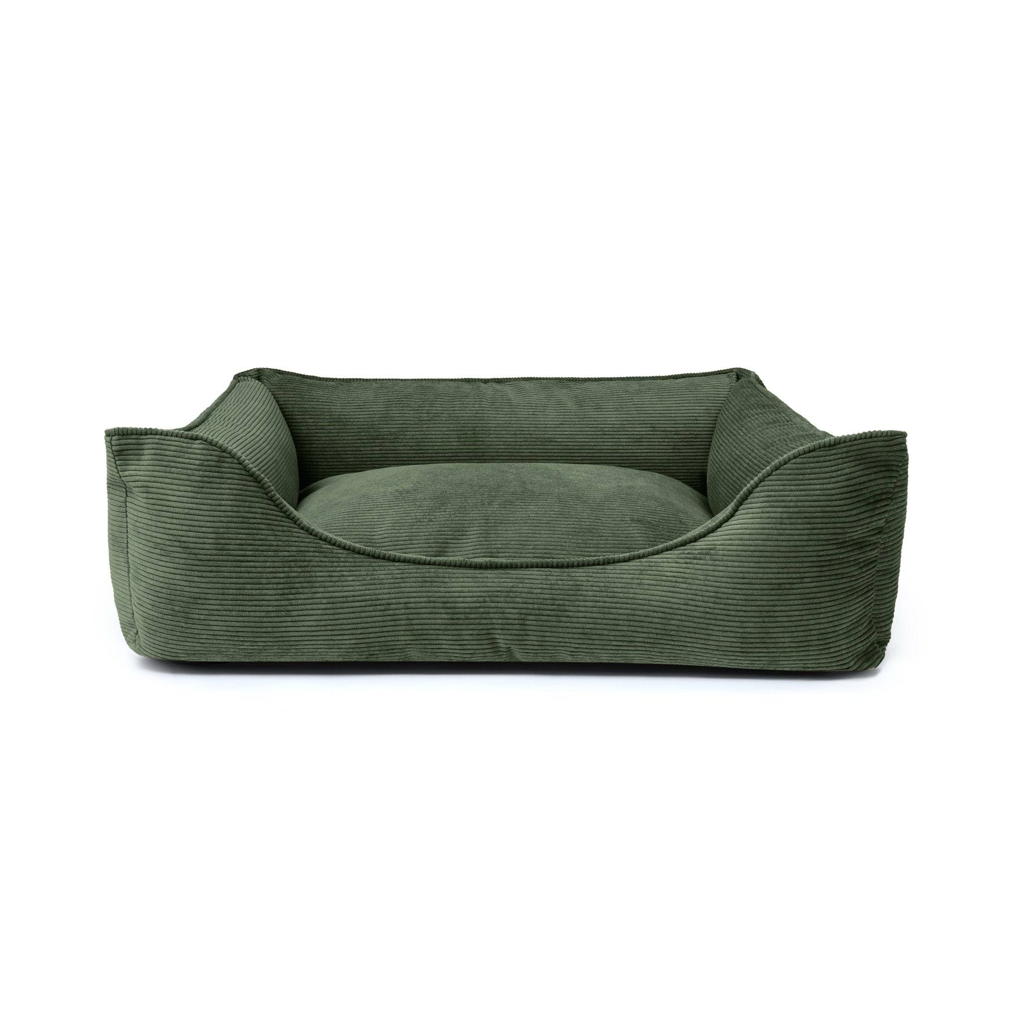 Forest green Ridge Lounge Pet Bed by The Dogs Company, showcasing a cozy, cushioned bed with raised edges for comfort.