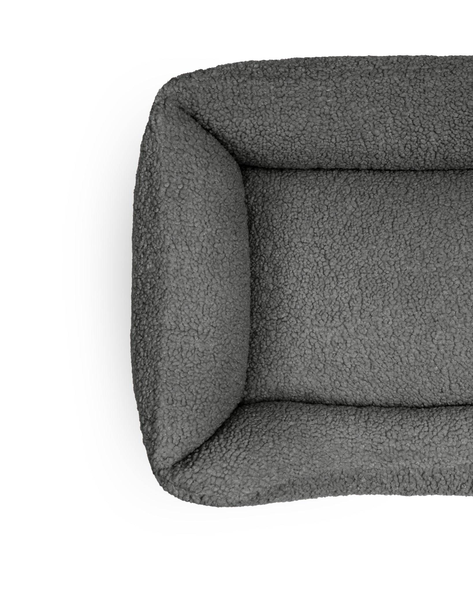 Pet teddy lounge bed in obsidian color by The Dogs Company, cozy cushioned pet bed for comfortable lounging.