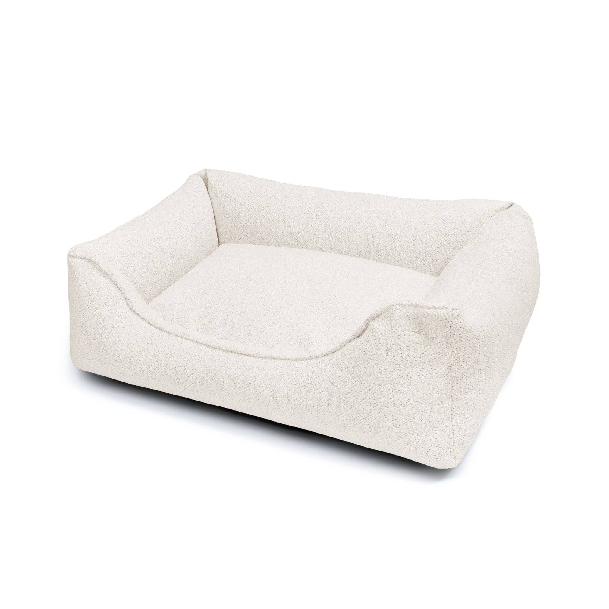 The Dogs Company Gaya Lounge Pet Bed in cozy fabric with cushioned sides, perfect for small dogs or cats to rest comfortably.