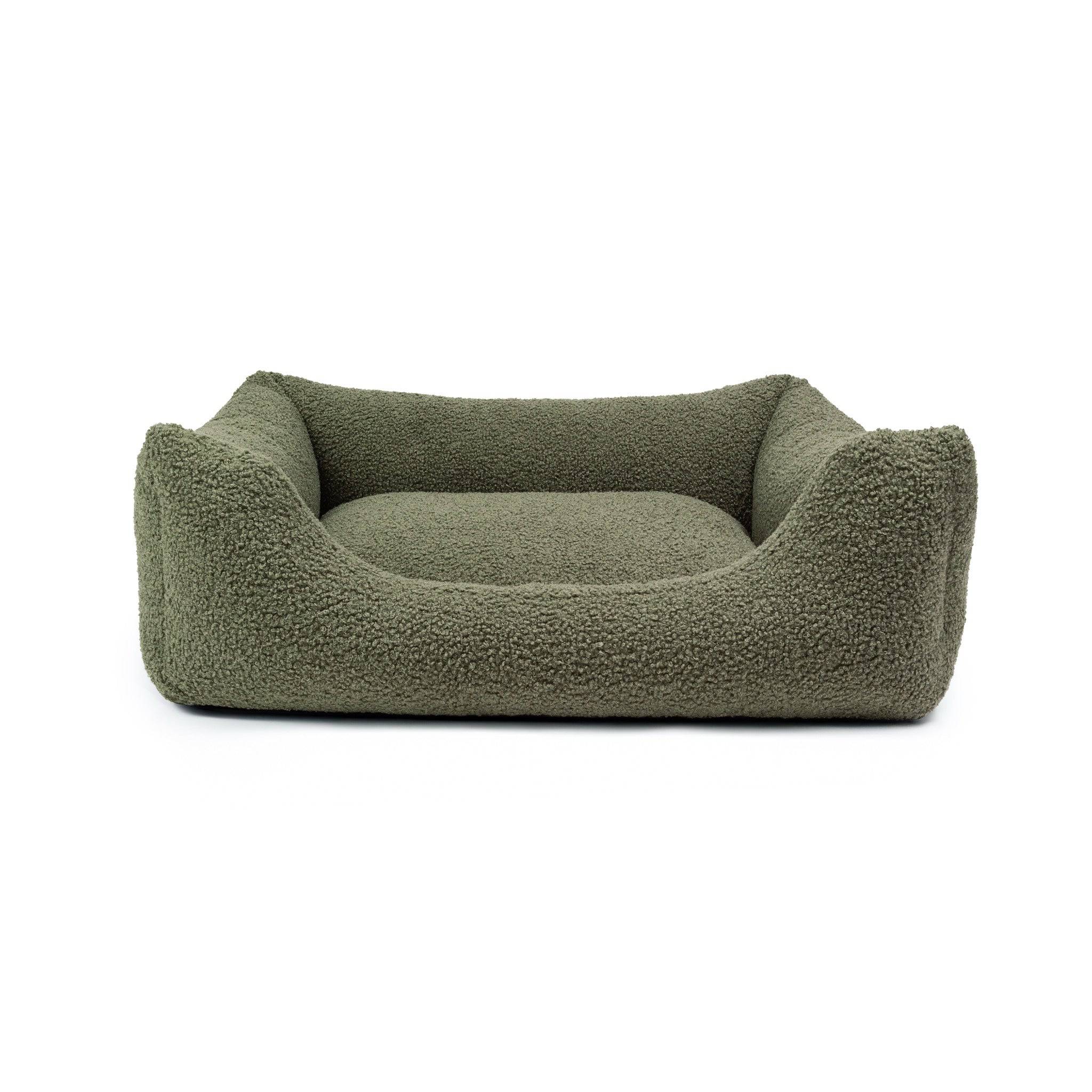 Soft bouclé lounge pet bed by The Dogs Company with plush cushions for comfortable relaxation.