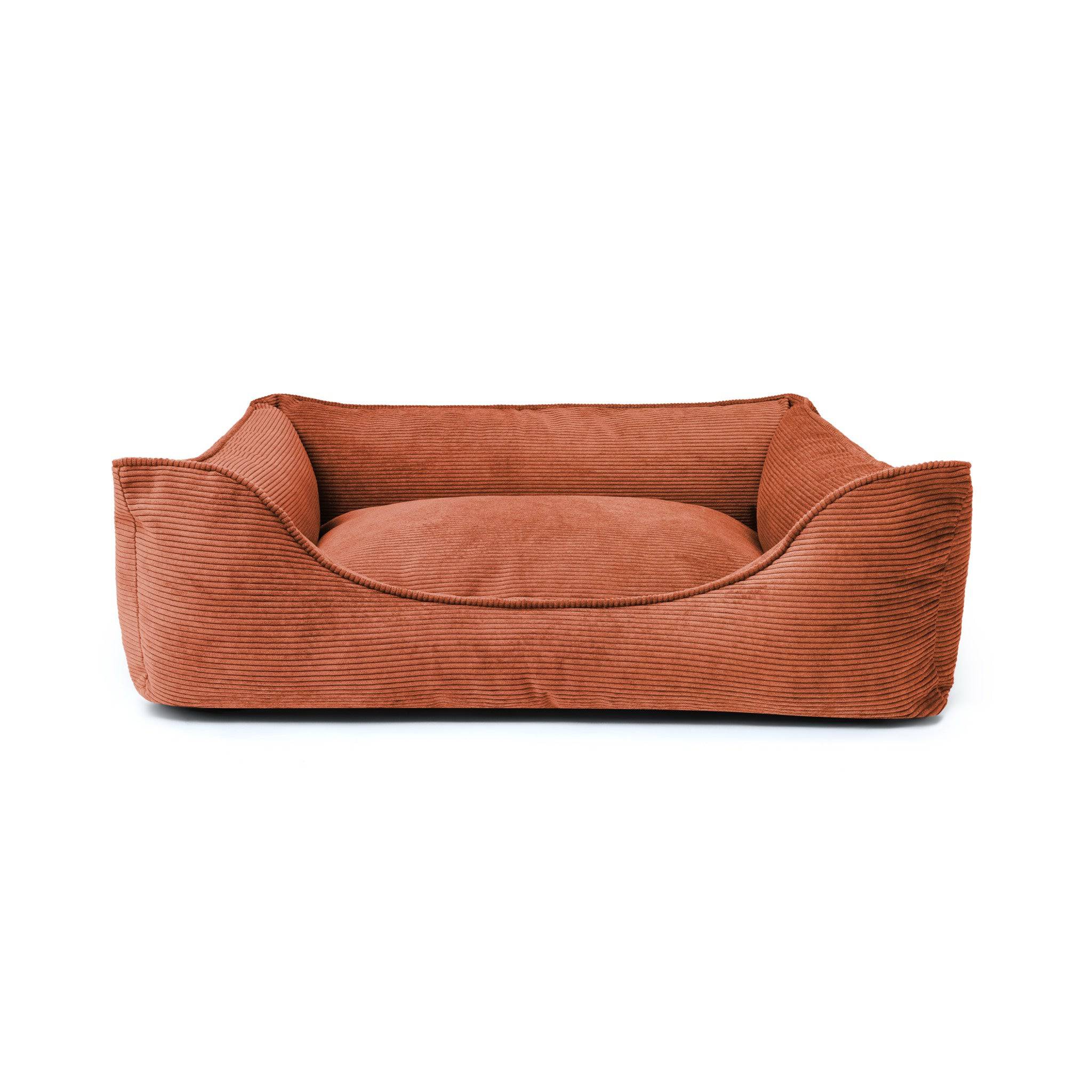 Comfortable Ridge Lounge Pet Bed by The Dogs Company with soft fabric and raised edges, perfect for cozy relaxation.