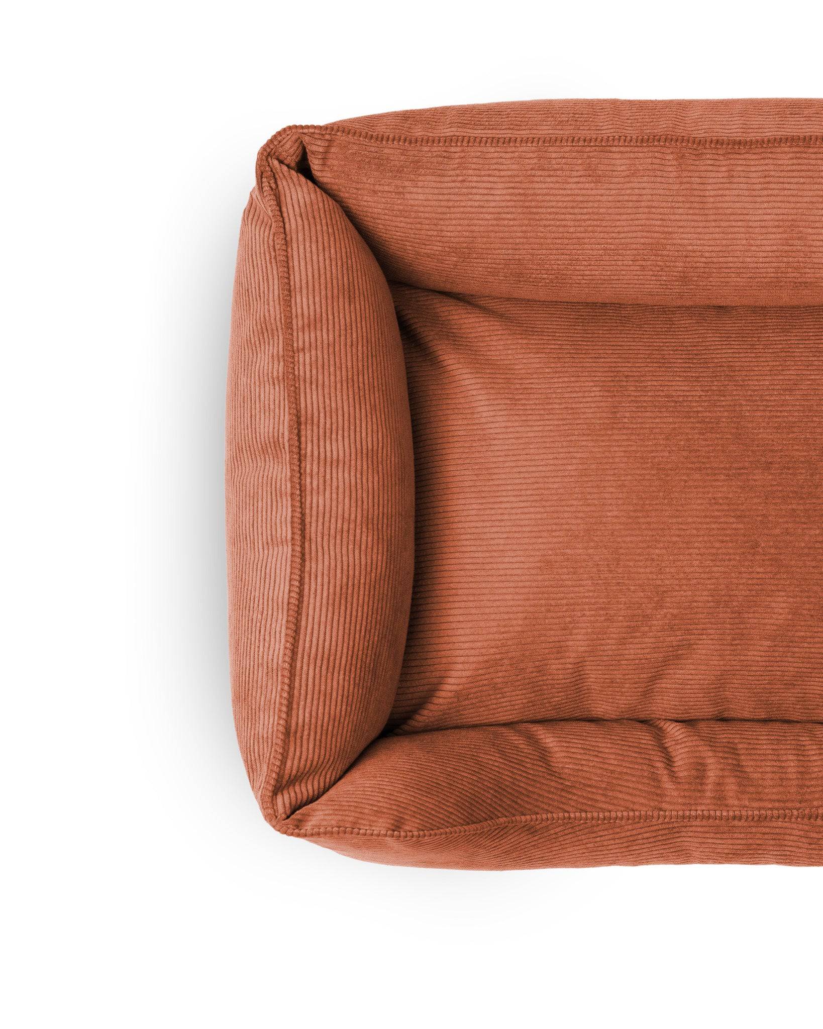 Soft Ridge Lounge Pet Bed by The Dogs Company, featuring plush fabric and cushioned sides for cozy pet relaxation.