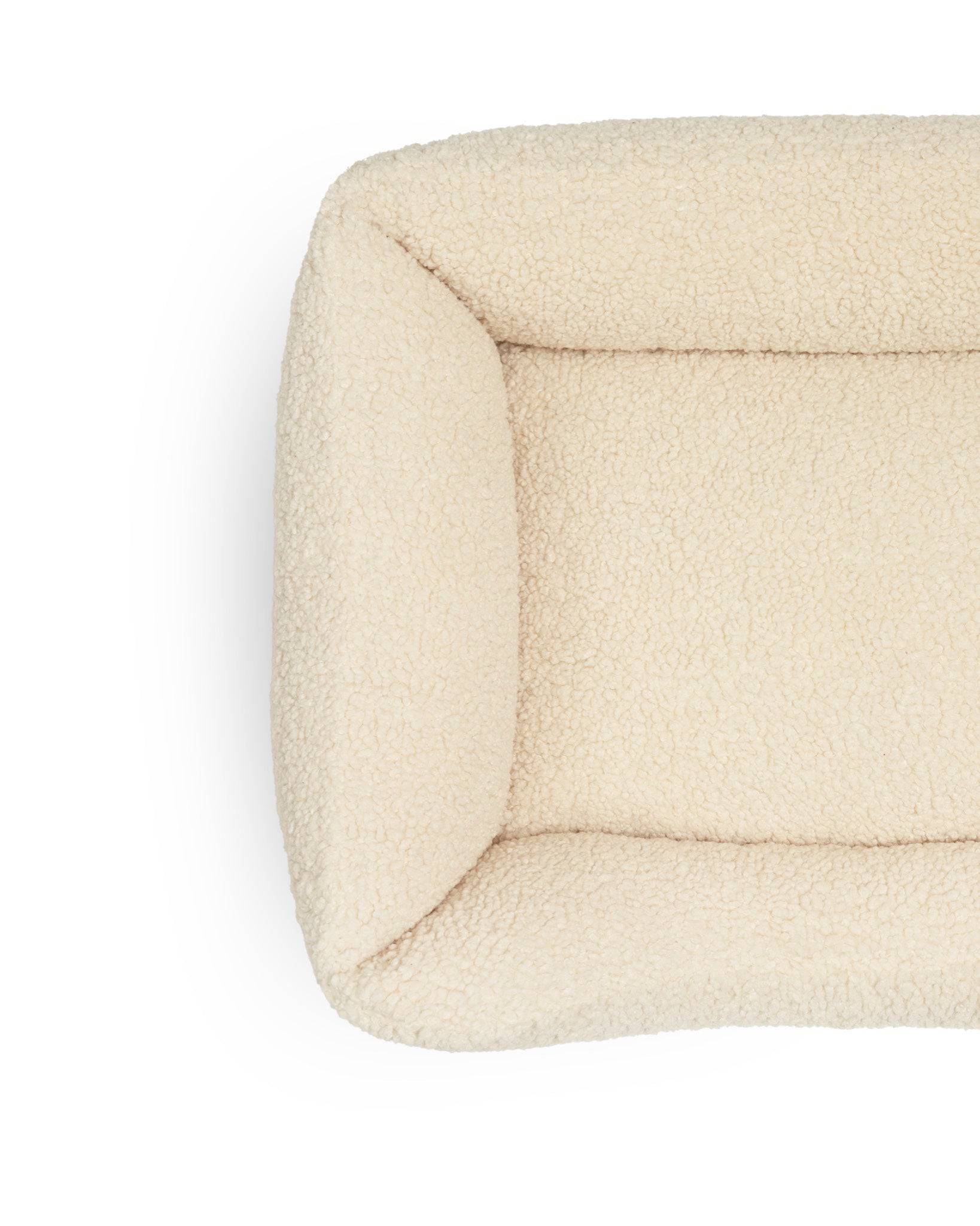 Soft Teddy Lounge Pet Bed by The Dogs Company with plush fabric and cozy design for comfortable indoor rest.