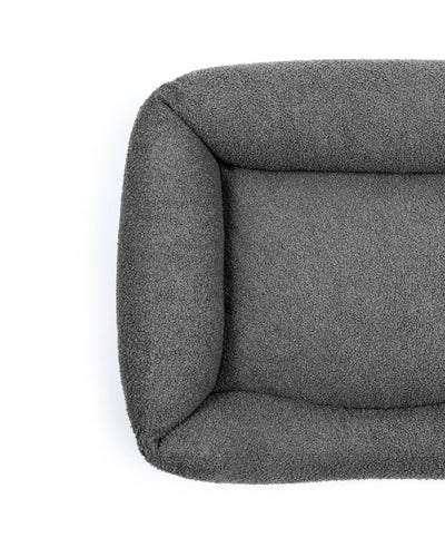 Obsidian bouclé lounge pet bed by The Dogs Company with soft, textured fabric and cozy design for dogs.