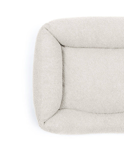 Pet Bouclé Lounge Bed by The Dogs Company in stone color, featuring a cozy, cushioned design for comfortable pet relaxation.