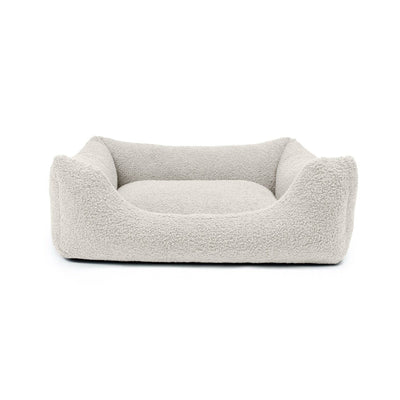 Stylish Bouclé Lounge Bed for pets by The Dogs Company, featuring a soft stone-colored fabric and cozy design.