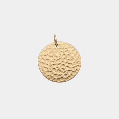 A round, hammered gold pendant charm with a small top loop, shown against a plain light gray background.