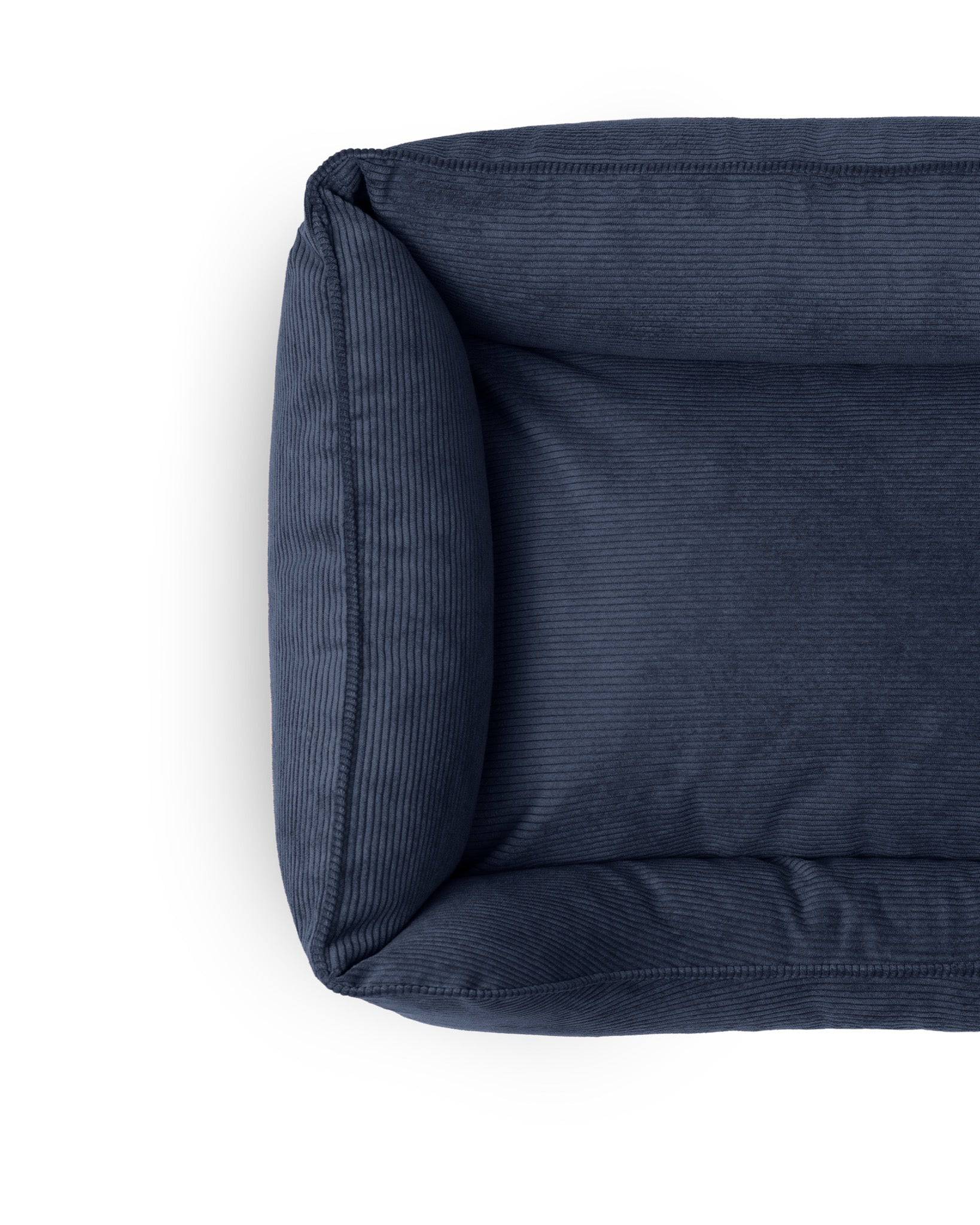 Midnight navy Ridge Lounge Pet Bed by The Dogs Company, with soft, cushioned sides and cozy interior for comfortable pet relaxation.
