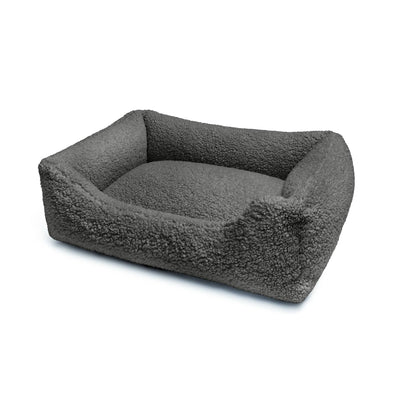 Soft black Teddy Lounge Bed for pets by The Dogs Company, featuring plush fabric and cozy design for comfort and relaxation.