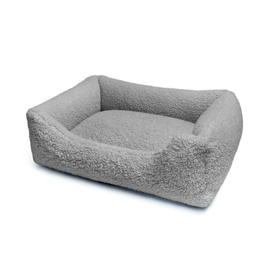 Soft teddy lounge pet bed by The Dogs Company in stone color, featuring plush fabric and cozy design for comfortable pet rest.
