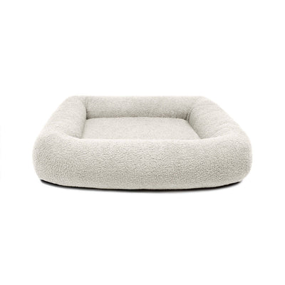 Cream Bouclé Infinity Pet Bed by The Dogs Company featuring soft, plush fabric and a cozy circular design for pets.