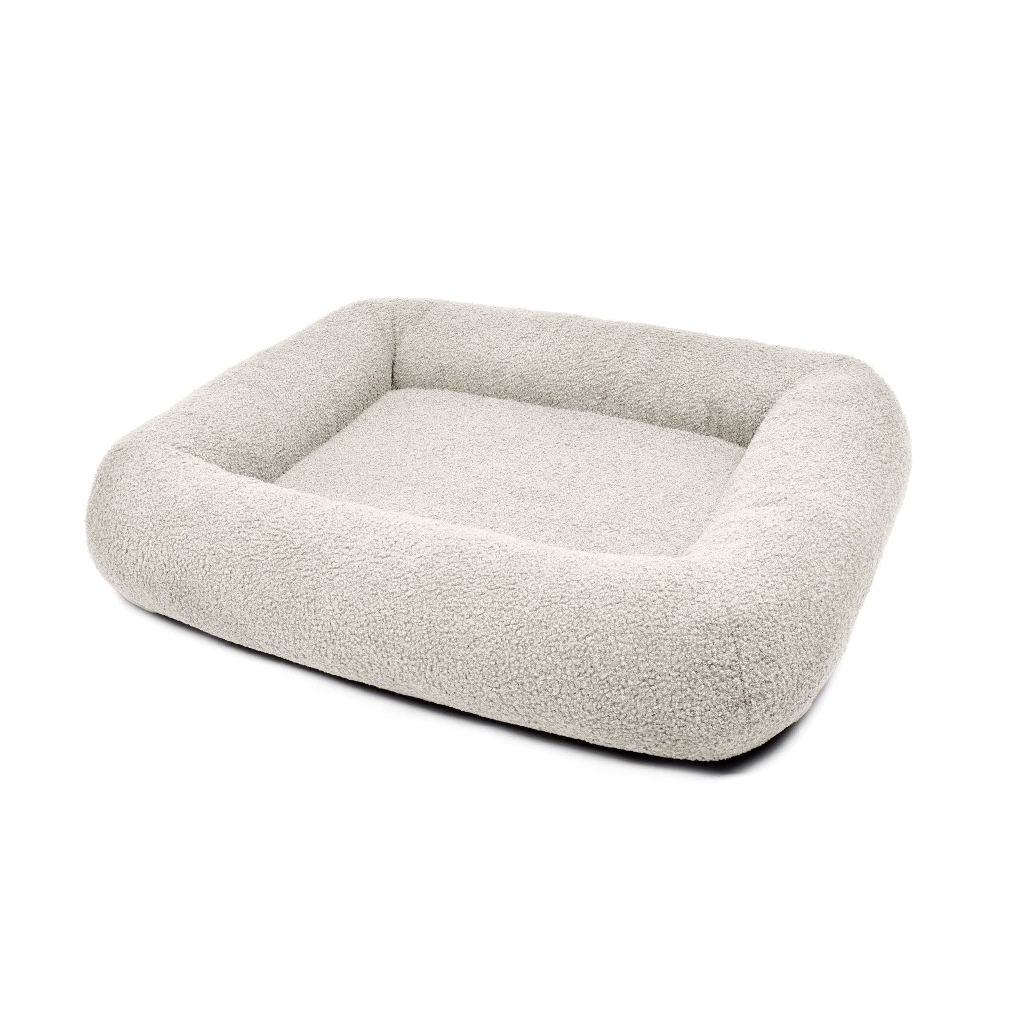 Cream Bouclé Infinity Pet Bed by The Dogs Company featuring a plush, circular design for cozy pet lounging.