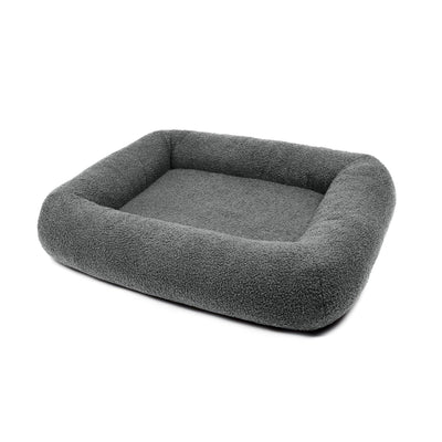Soft stone Bouclé Infinity Pet Bed by The Dogs Company featuring a cozy, circular design and plush fabric for pets' comfort.
