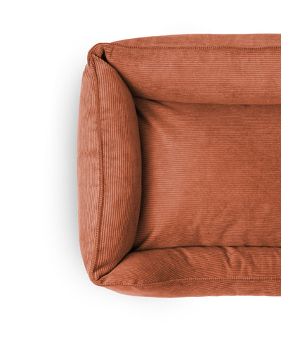 Cozy Ridge Lounge Pet Bed by The Dogs Company with plush cushions and supportive sides for comfortable pet relaxation.